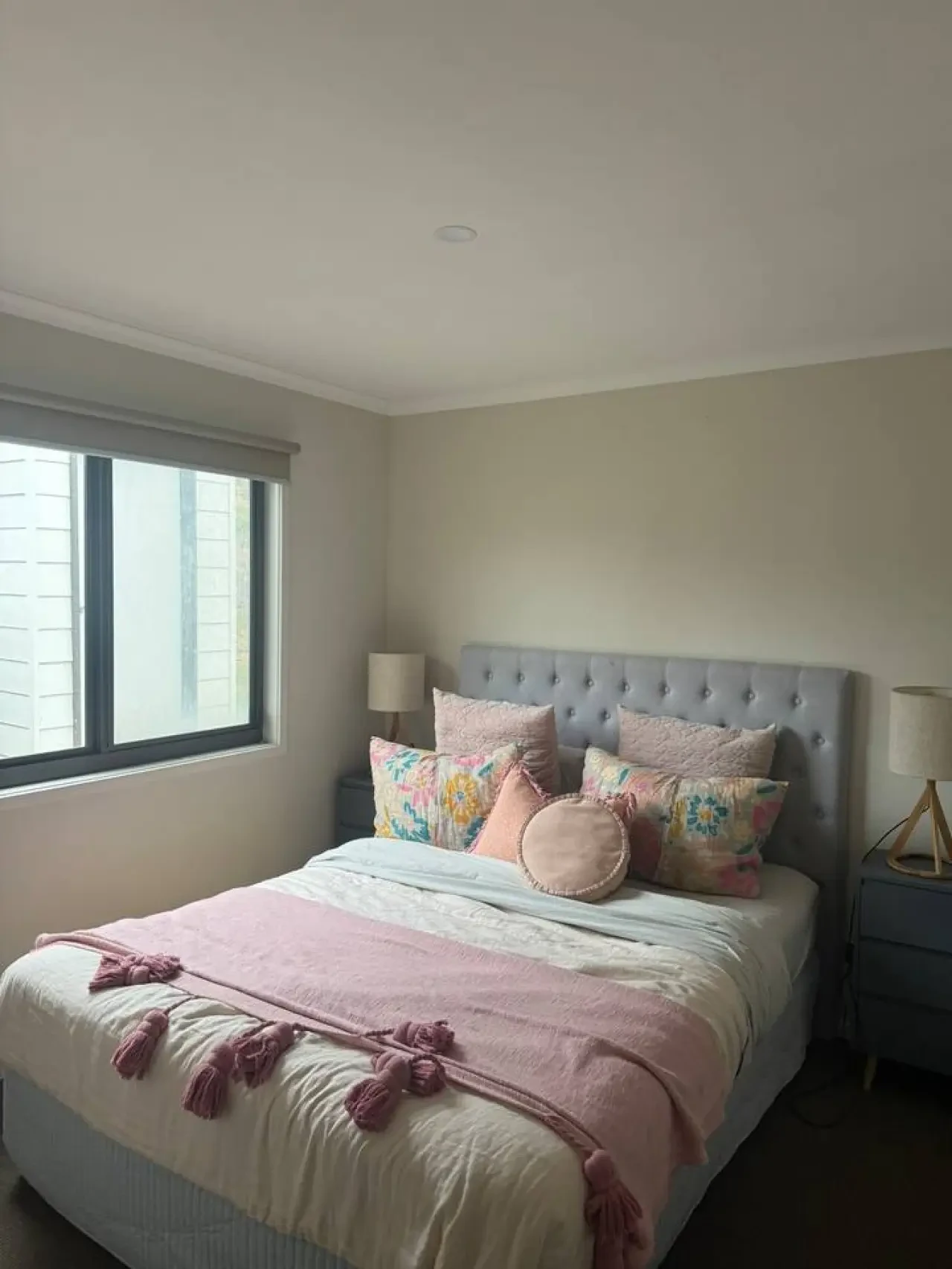 Lancaster Lodge queen bedroom with pink bedding and tufted headboard
