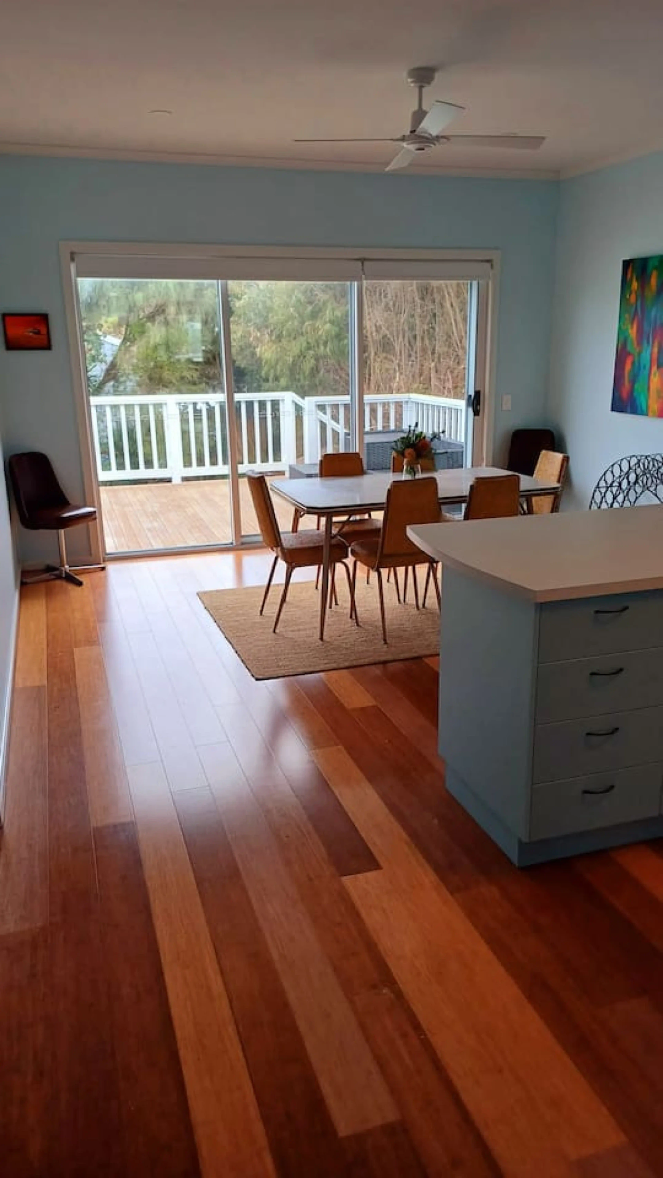 Ocean Blue — kitchen and dining area with sliding doors to deck