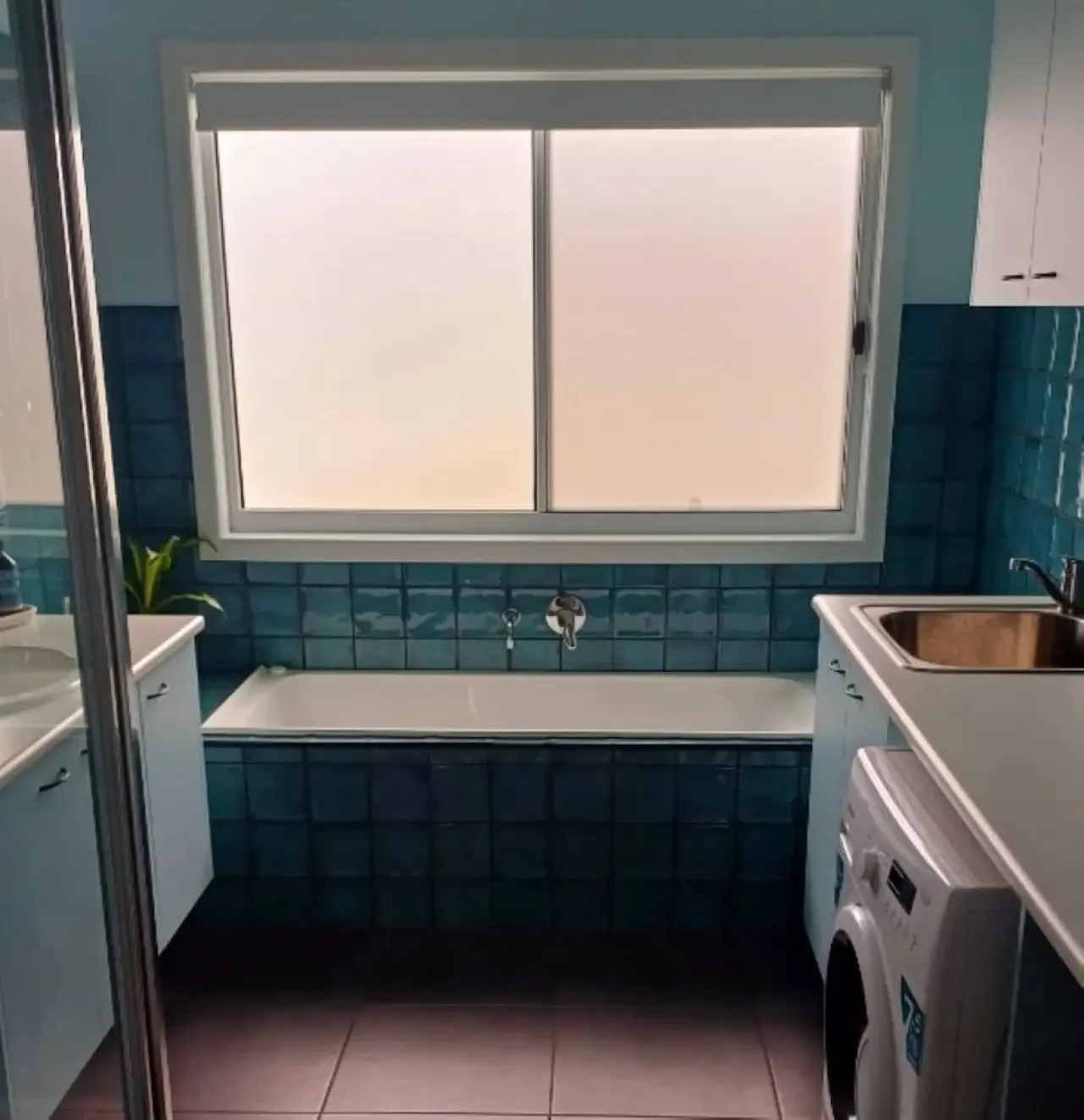 Ocean Blue — bathroom with teal tiles and bathtub