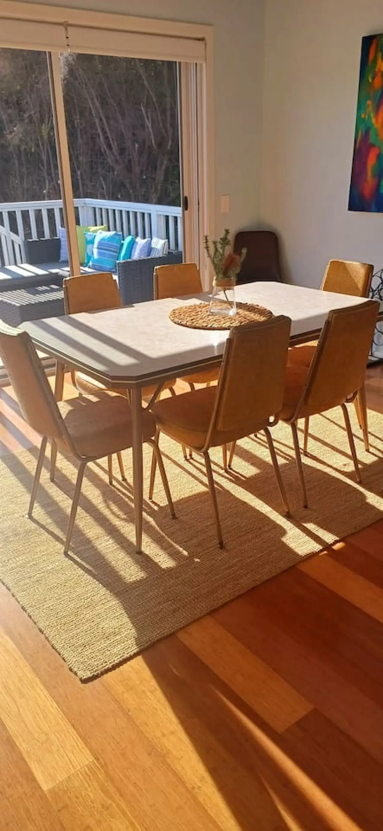 Ocean Blue — dining room with retro table and deck view