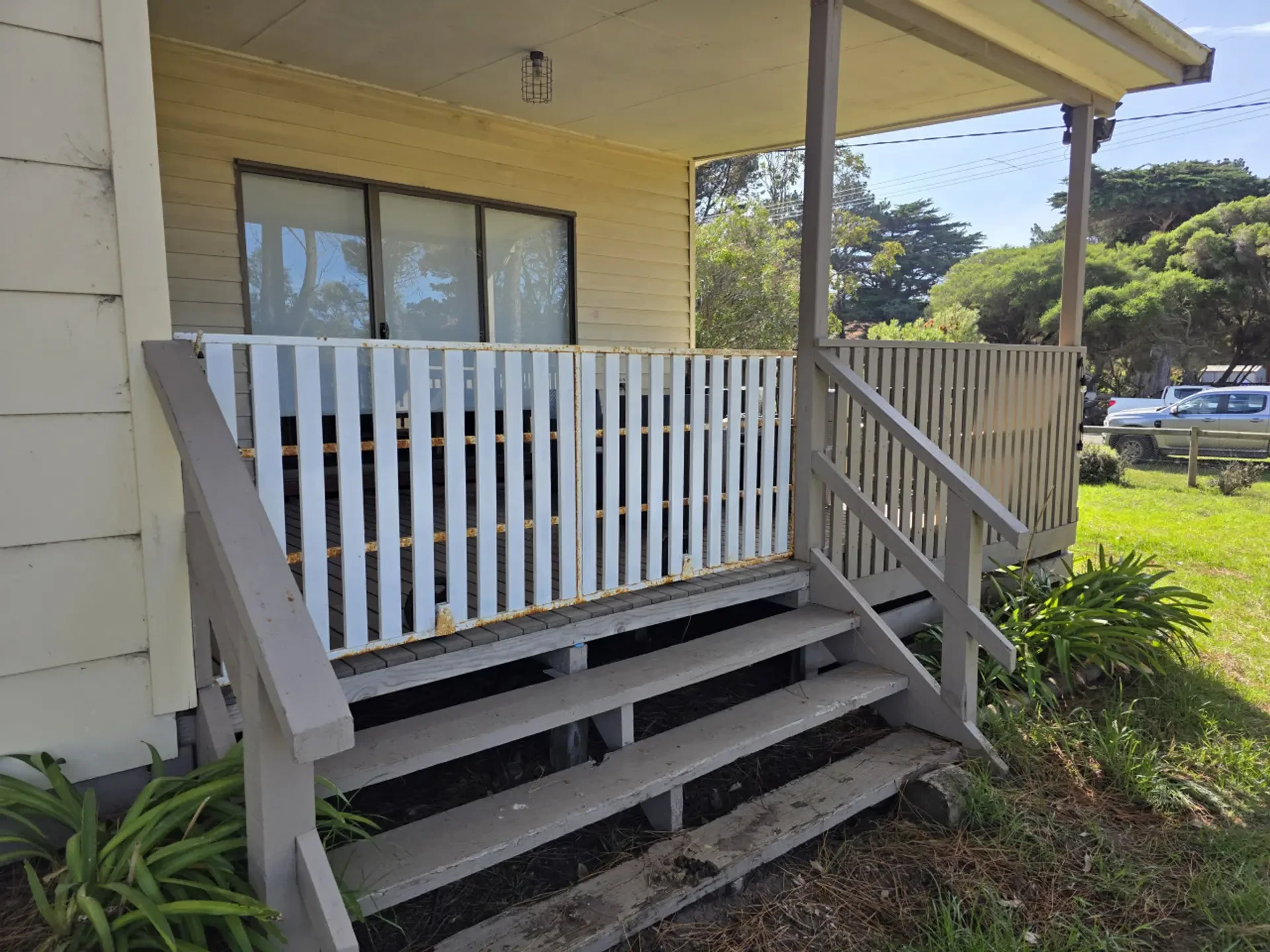 House exterior with covered front porch and steps