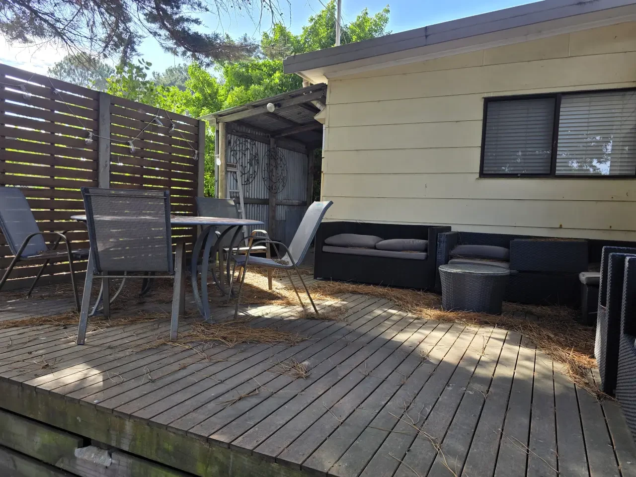 Rear deck with outdoor dining table and lounge sofa