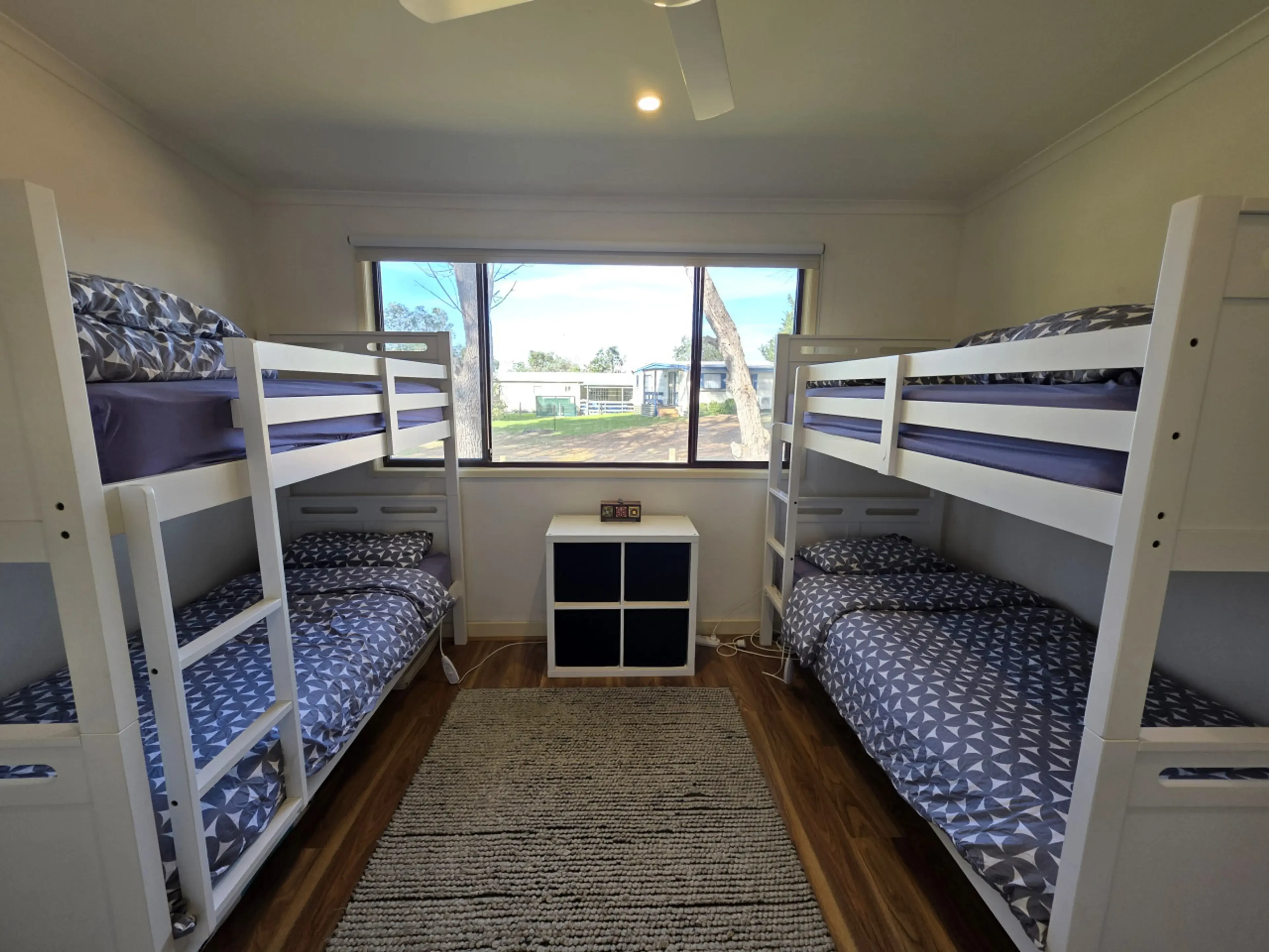 Bunk room with two sets of bunk beds and blue bedding