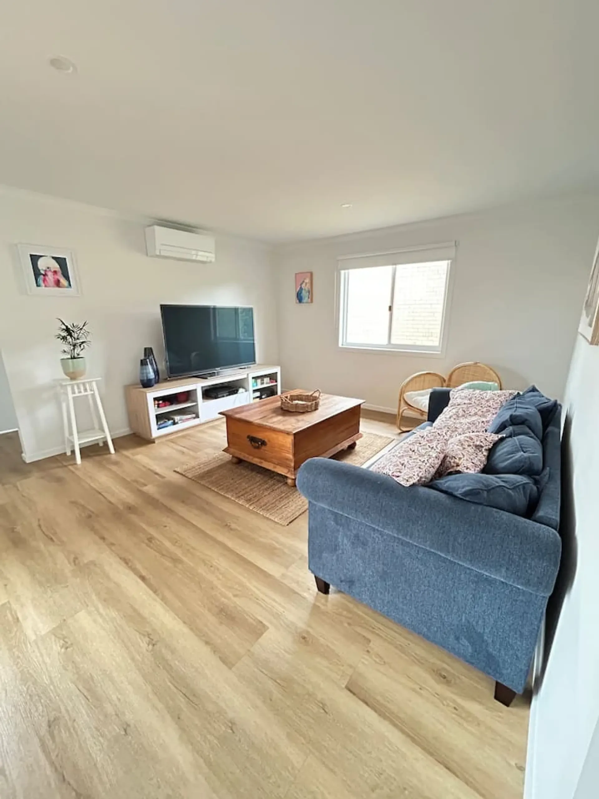 Roo Views living room with blue sofa and timber coffee table