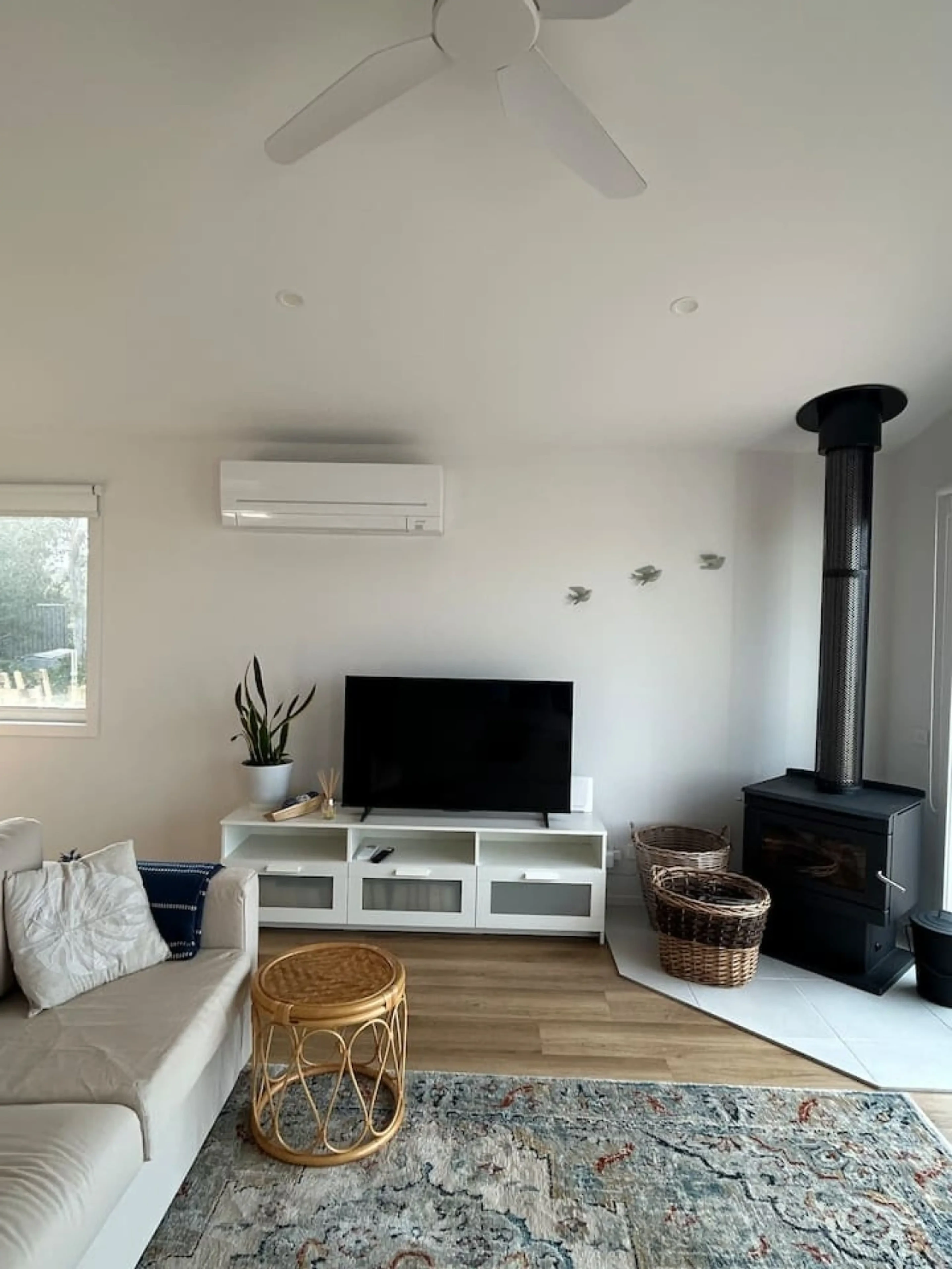 Roo Views living room with wood stove and TV