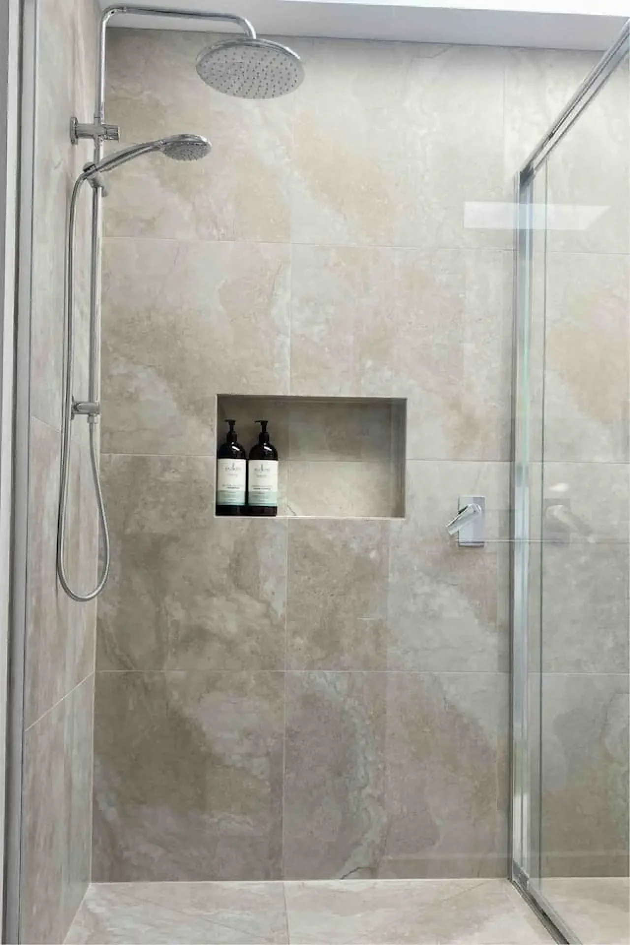 Marble-look shower with rain head and built-in niche