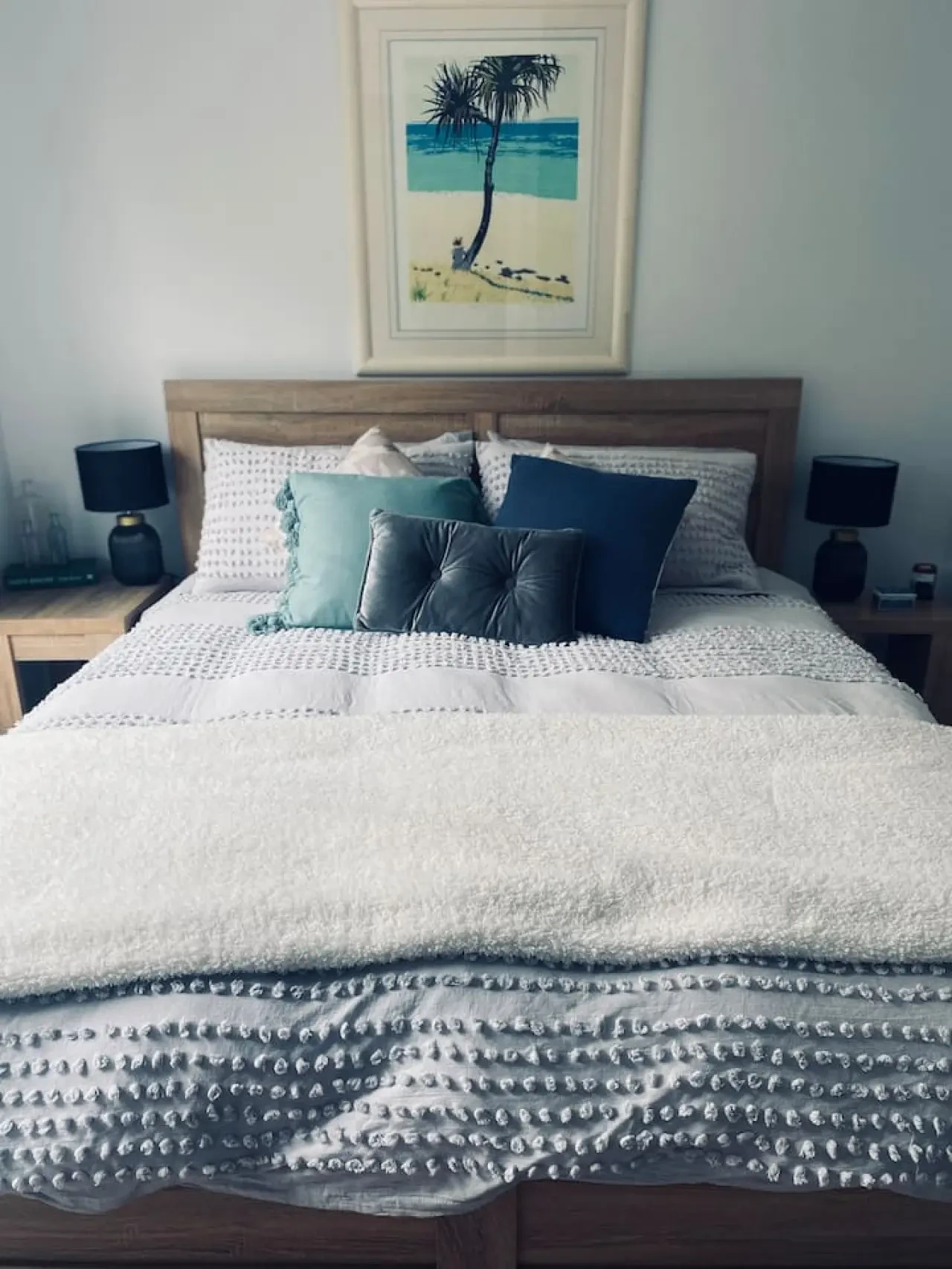Master bedroom with king bed and coastal artwork
